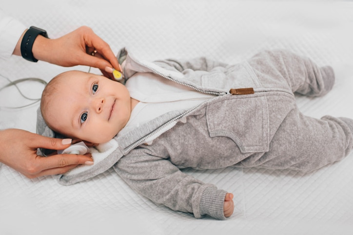 Baby being fit with hearing test diodes