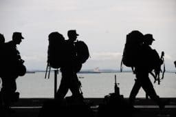 Silhouette of soldiers walking.