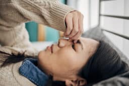Woman lying down with a sinus headache