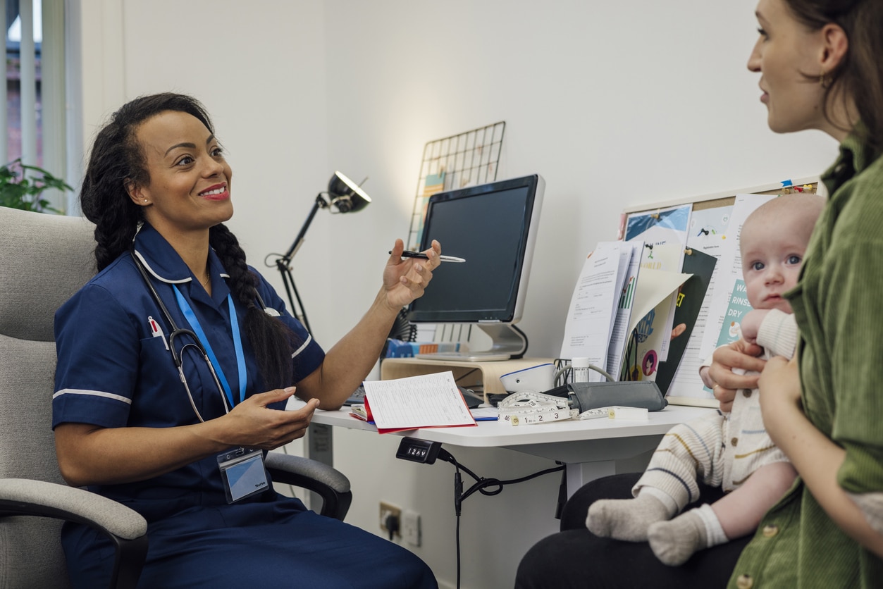 Mother and her baby consulting with a doctor.