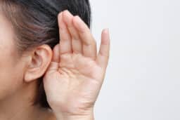 Close up of hand behind ear
